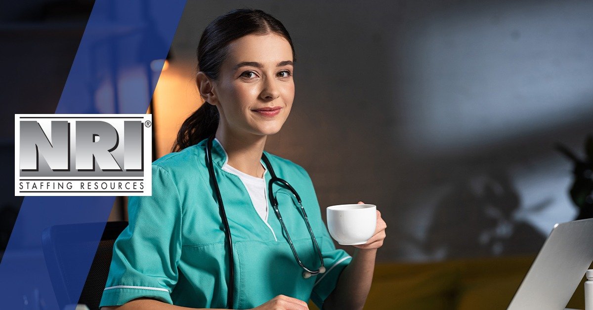 a female nurse in scrubs sipping coffee