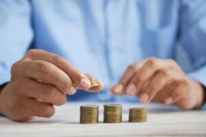 Hands stacking coins to represent salary expectations 2026, pay growth, and compensation planning in today’s job market.