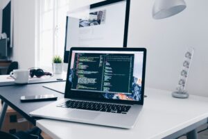 IT professional working on in-demand tech skills including coding and software development on a laptop