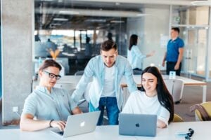IT staff augmentation professionals working alongside full-time team members at office meeting
