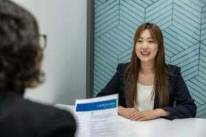 does a staffing agency cost money — smiling job seeker working on laptop searching for free staffing agency support