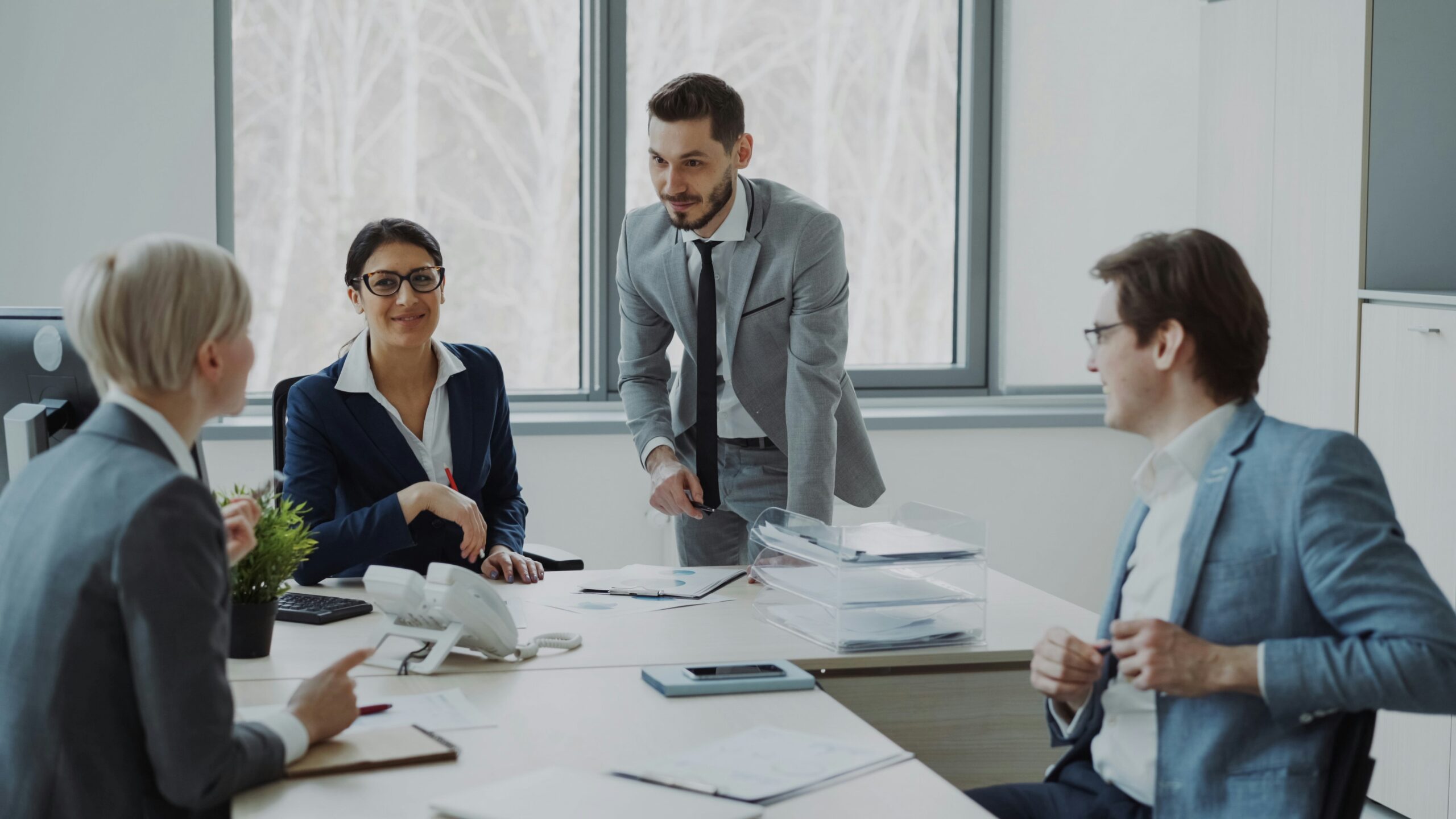 government temp staffing — hiring manager presenting workforce documents to agency team in professional office meeting.