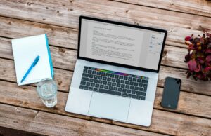 resume tips DC 2026 — job seeker writing an executive summary section on a laptop resume at a clean outdoor workspace