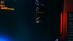 IT jobs DC no experience — cybersecurity professional monitoring code and threat data on a screen in a DC area IT environment