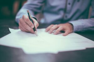 legal staffing agency candidate reviewing and signing placement documents during a specialized legal role onboarding