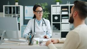 healthcare administrative assistant using patient communication skills during a consultation appointment at a medical office