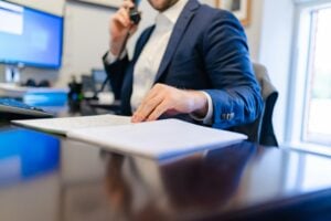 legal assistant interview — hiring manager reviewing candidate documents at a law firm desk during a job interview
