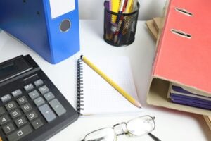 new accounting graduate searching for accounting jobs through a staffing agency with organized desk and financial documents