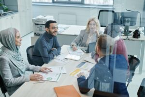 Hiring manager meeting with her team to plan how to hire during a hiring freeze
