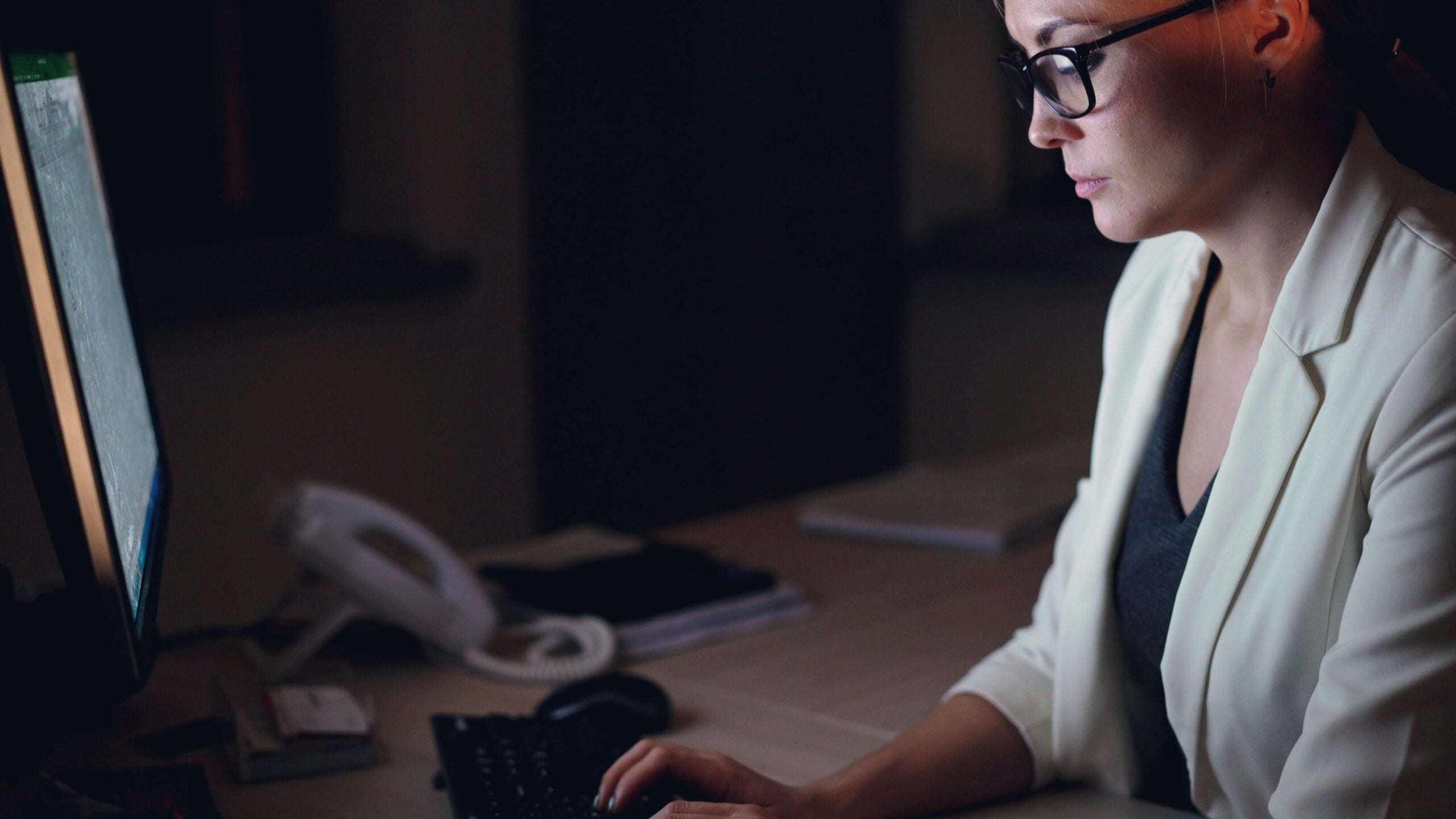legal assistant interview — professional woman preparing for a law firm interview by researching the firm on a computer at her desk