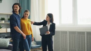 A leasing agent showing an apartment to prospective renters — property management staffing keeps every role covered.