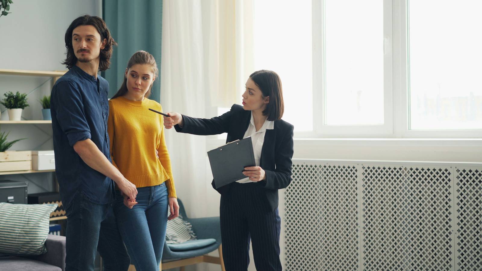 A leasing agent showing an apartment to prospective renters — property management staffing keeps every role covered.