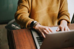 A person working at a laptop, preparing to explain a gap in your resume.