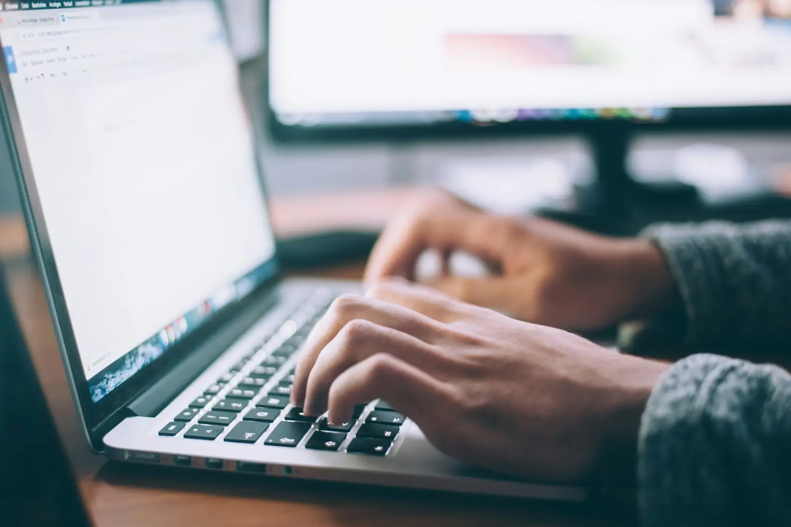 A job seeker using AI to write their resume on a laptop.